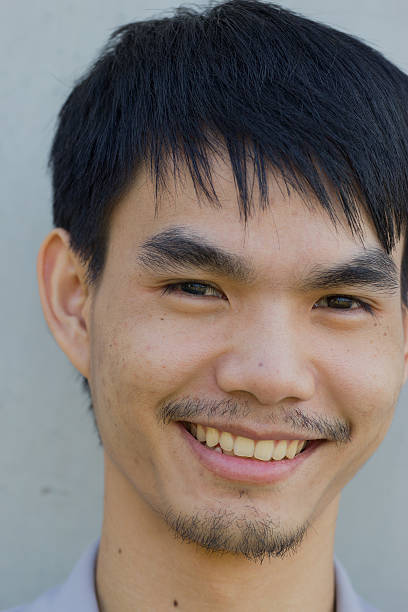 istock asian Young man smiling, portrait 460141733