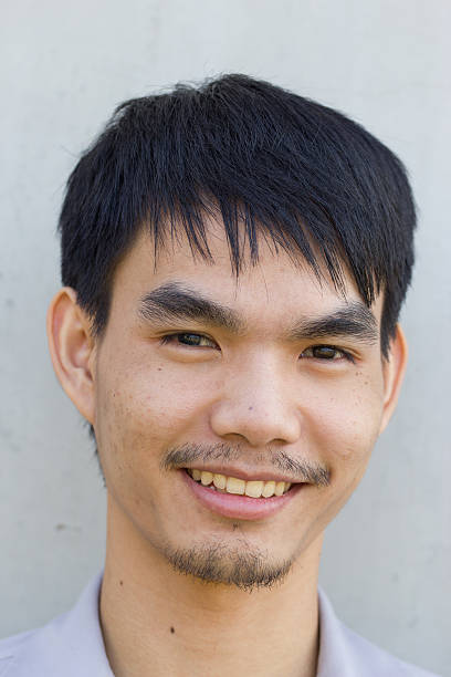 istock asian Young man smiling, portrait 460142513