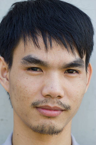 istock asian Young man smiling, portrait 460142515