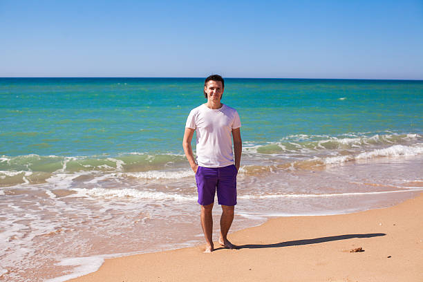 istock Young man on tropical beach vacation 460142539