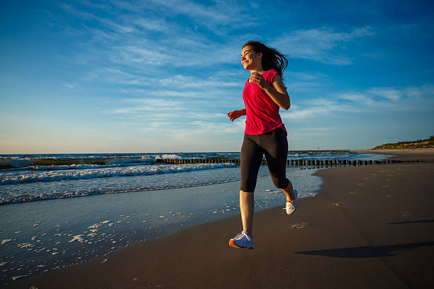istock Girl running on beach 460147115