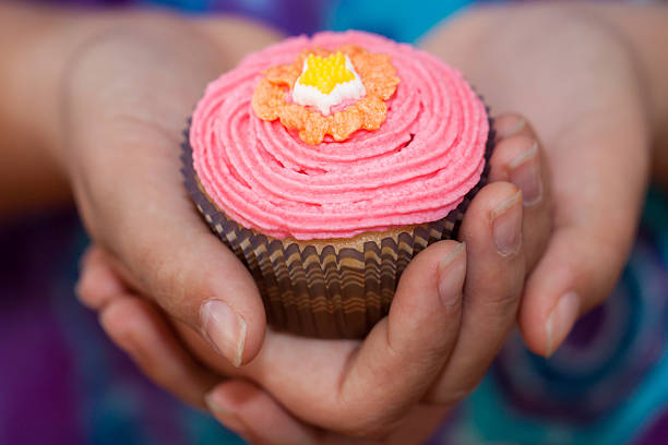 mini cupcakes decorated with orange flowers on a wooden table