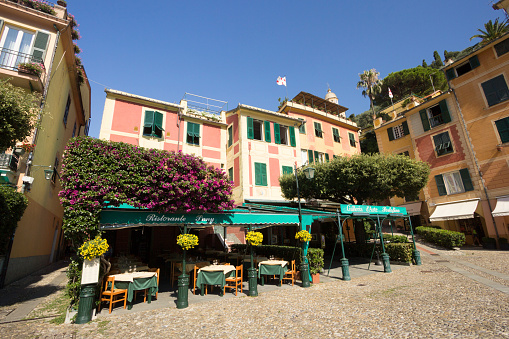Portofino, Italy - August 31, 2013: A tranquil scene with a restaurant in the scenic village of Portofino on the Italian Riviera. The restaurant name is visible.