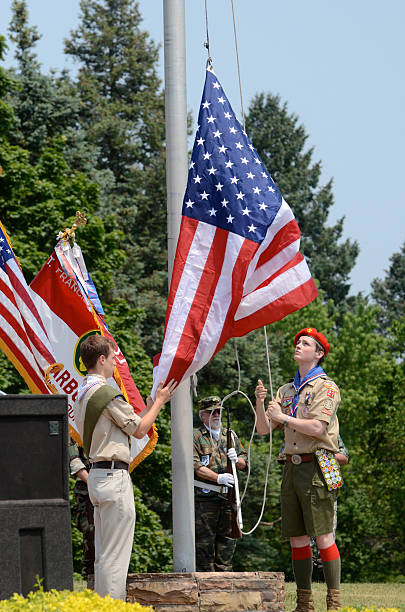 Boy scouts raising the flag stock photo