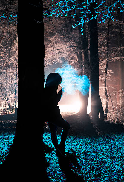 istock Dark figure in a misty winter forest at night 460181239