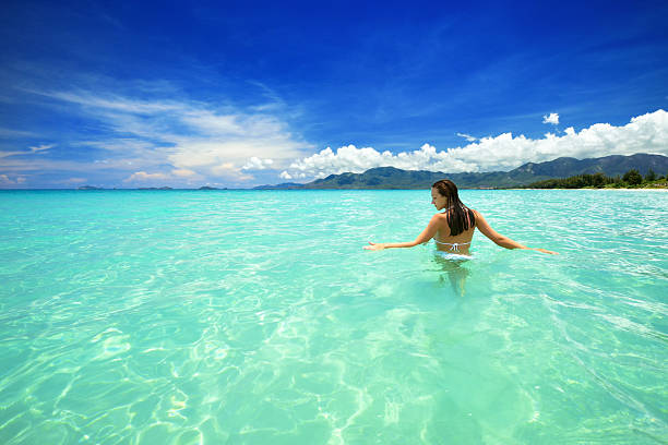 istock Woman in bikini at tropical beach 460182841