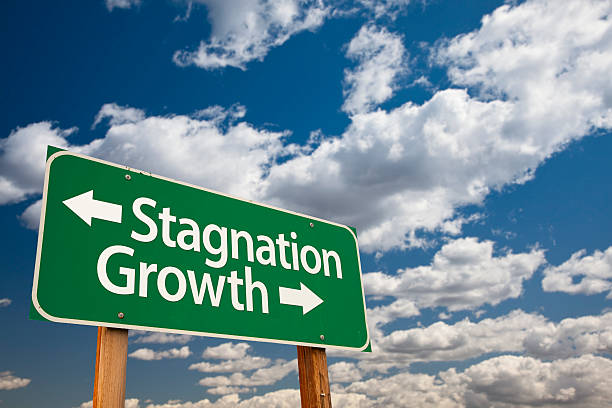 istock Stagnation or Growth Green Road Sign Over Clouds and Sky 460190129