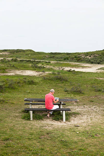 istock Retired senior man resting and using his tablet at table. 460204605