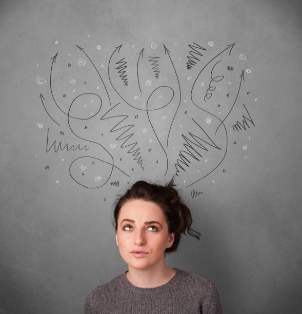 istock Young woman thinking with arrows over her head 460205189