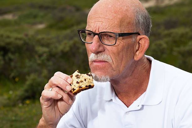 istock Retired man with beard and glasses having lunch. 460210403