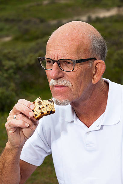 istock Retired man with beard and glasses having lunch. 460210485