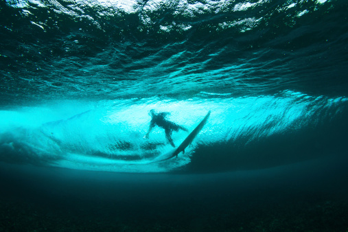 Underwater view of surfer and crystal clear wave