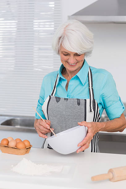 istock Smiling woman mixing pastry 460213213