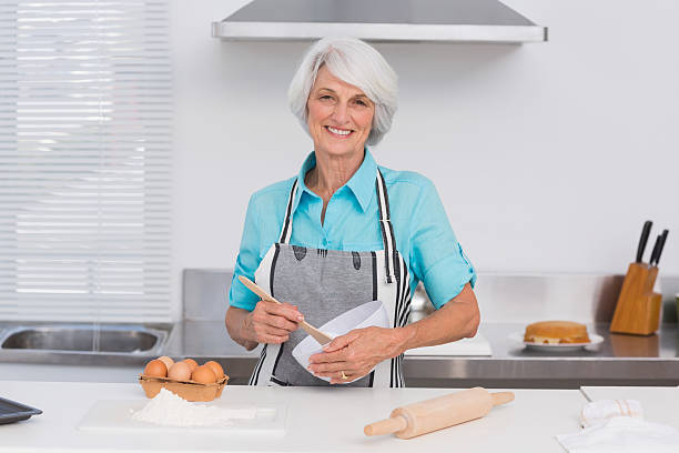 istock Elderly woman whisking pastry mix 460213245