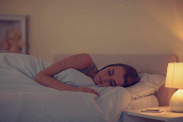 istock Pretty sleeping woman lying in her bed 460213477