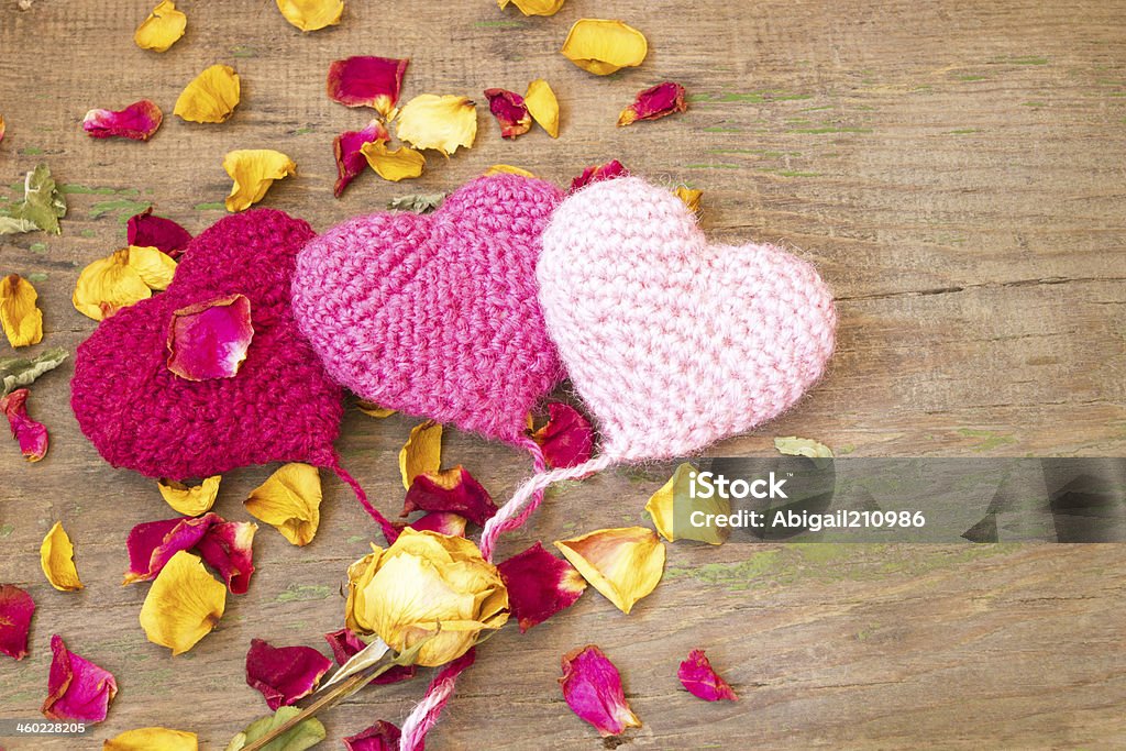 cute knitted hearts on a wooden background Affectionate Stock Photo