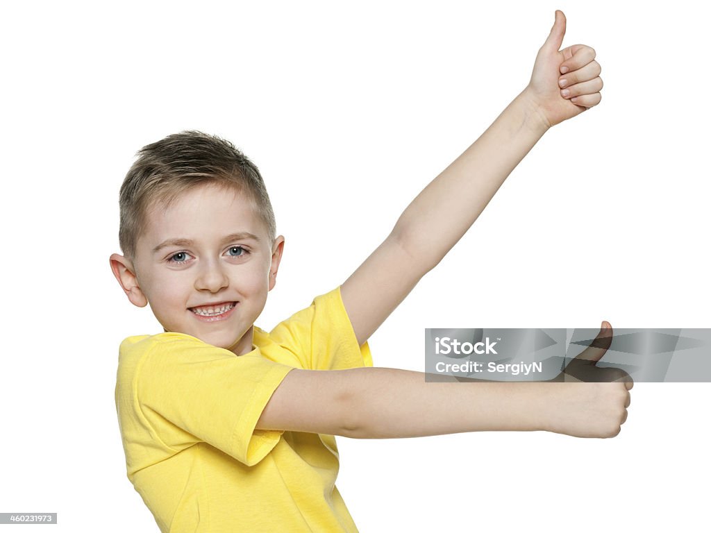 Young boy with his thumbs up Young boy holds his thumbs up on the white background Beautiful People Stock Photo
