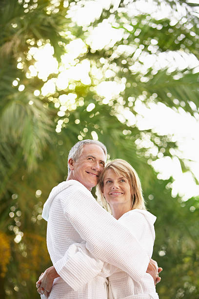 istock Couple In Bathrobes Hugging By Palm Trees 460239963
