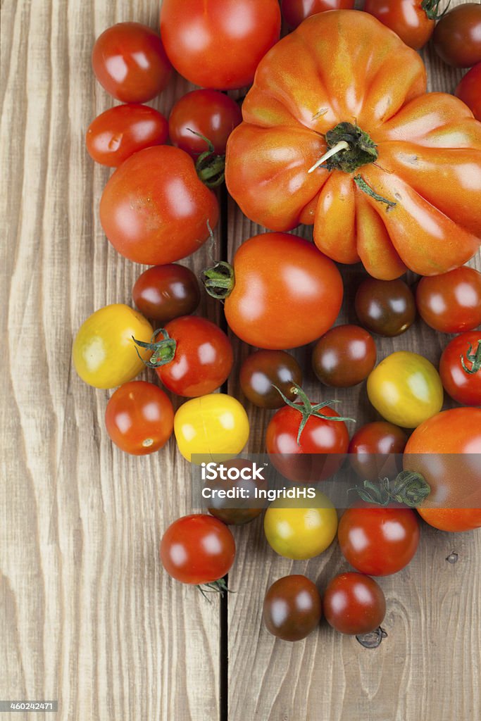 Tomatoes Yellow, red and black tomatoes on wooden background Backgrounds Stock Photo