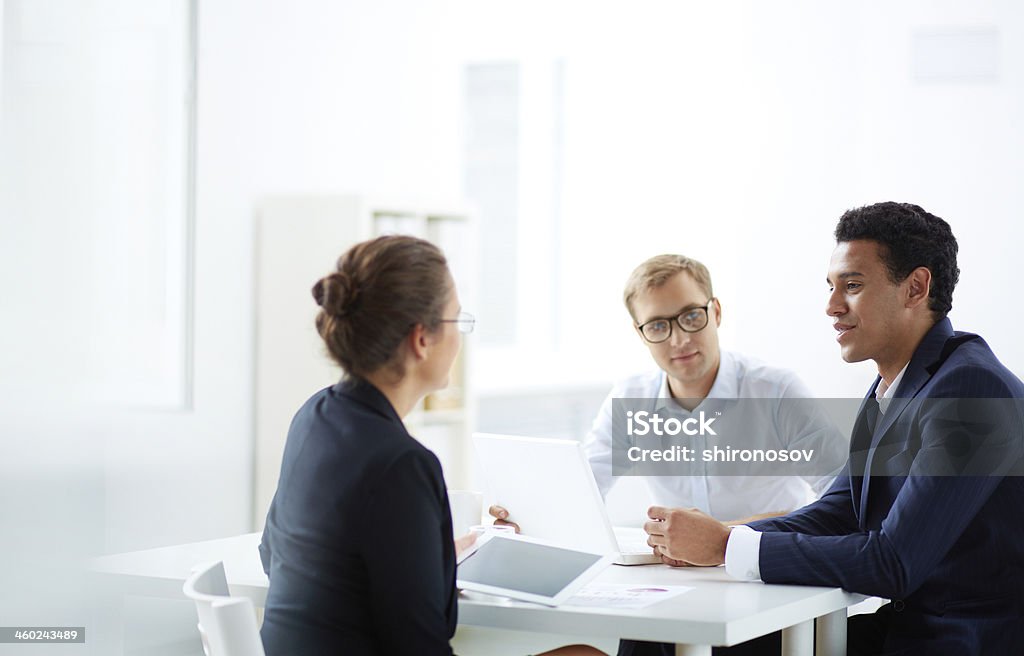 Planning work Portrait of smart business partners communicating at meeting Adult Stock Photo