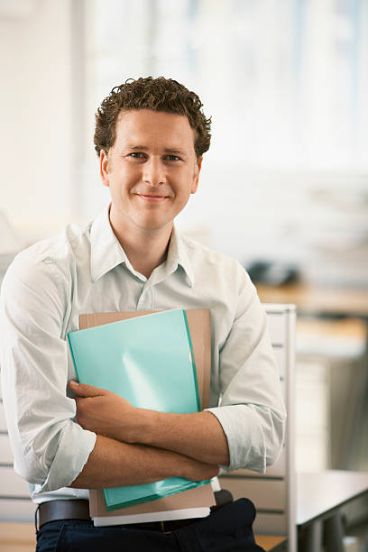 istock Businessman With Files Standing By Cubicle 460249163