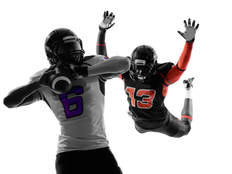 two american football players quarterback sacked in silhouette shadow on white background