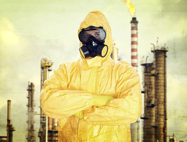 istock Man in chemical protective suit over factory 460253871