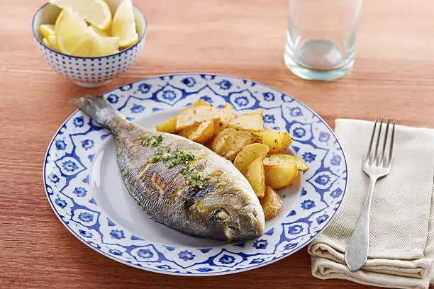 Photo of Fried gilt head bream with potatoes