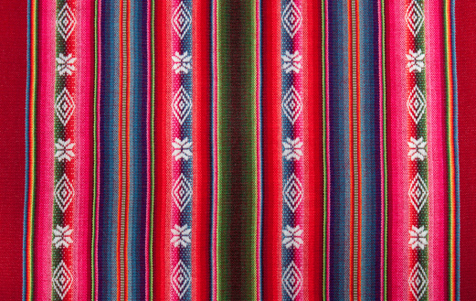 This is an abstract close up photograph of the handles of several colorful fabric purses for sale in Playa Del Carmen, Mexico