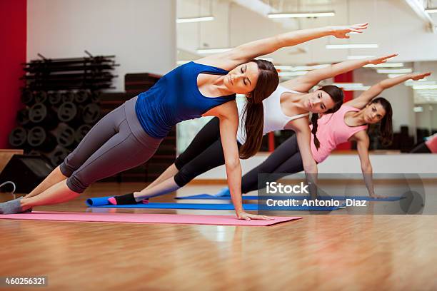 Doing A Side Plank For Yoga Class Stock Photo - Download Image Now - 20-29 Years, Activity, Adult