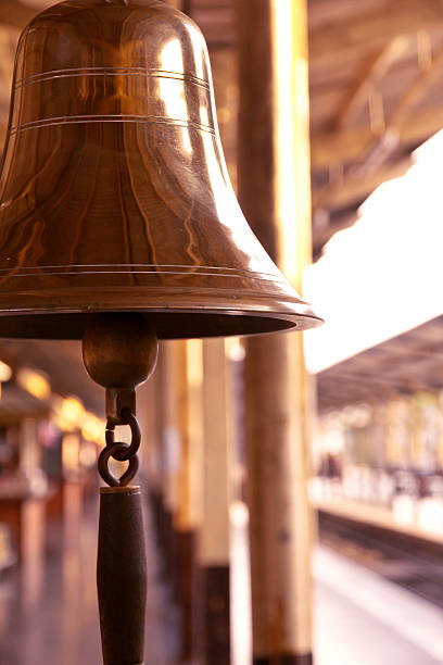 istock old bell in train station with sunrise light 460257451