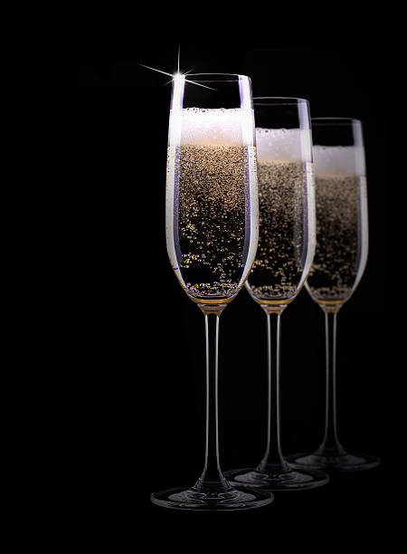 istock champagne glass on black background 460257519