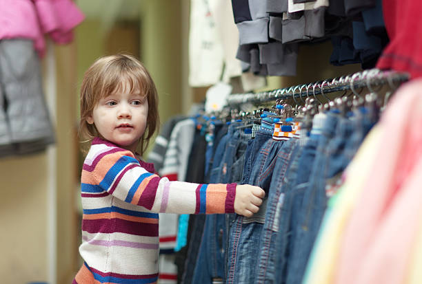 istock child  chooses jeans at shop 460257551