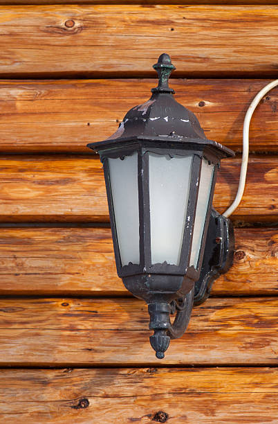 istock Outside lamp on wooden cottage 460273031