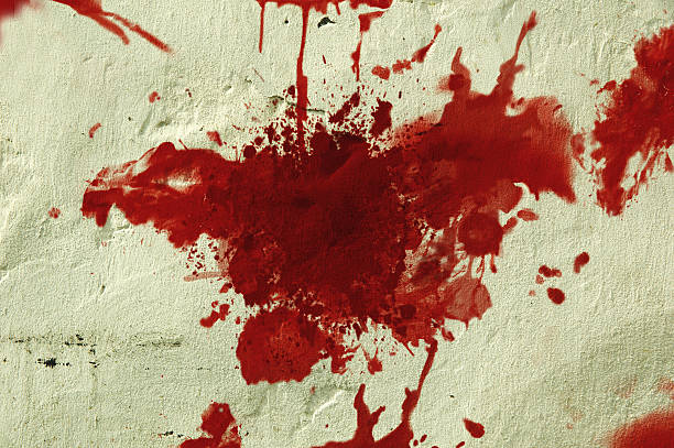 Red blood splatter on a wall. stock photo