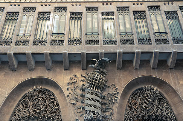 Palau Guell side wall with metallic bird atop crown created by Antonio Gaudi