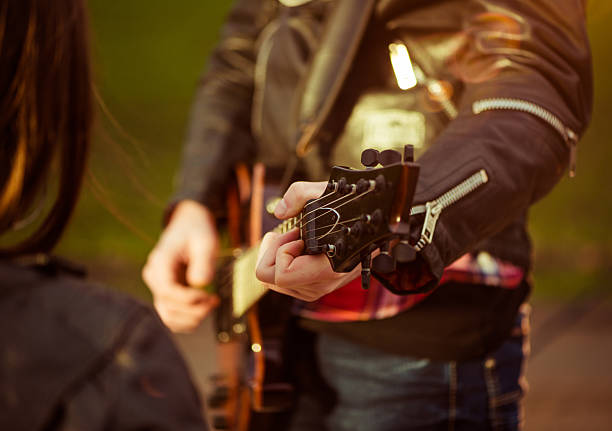 istock guitarist playing guitar outdoor 460302779