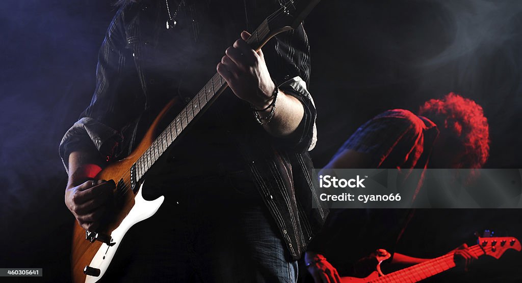 rock  live concert rock musicians playing at a live concert Performance Group Stock Photo