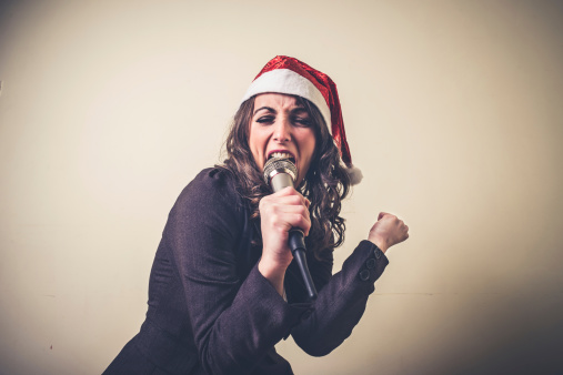 christmas businesswoman singing with microphone on white background