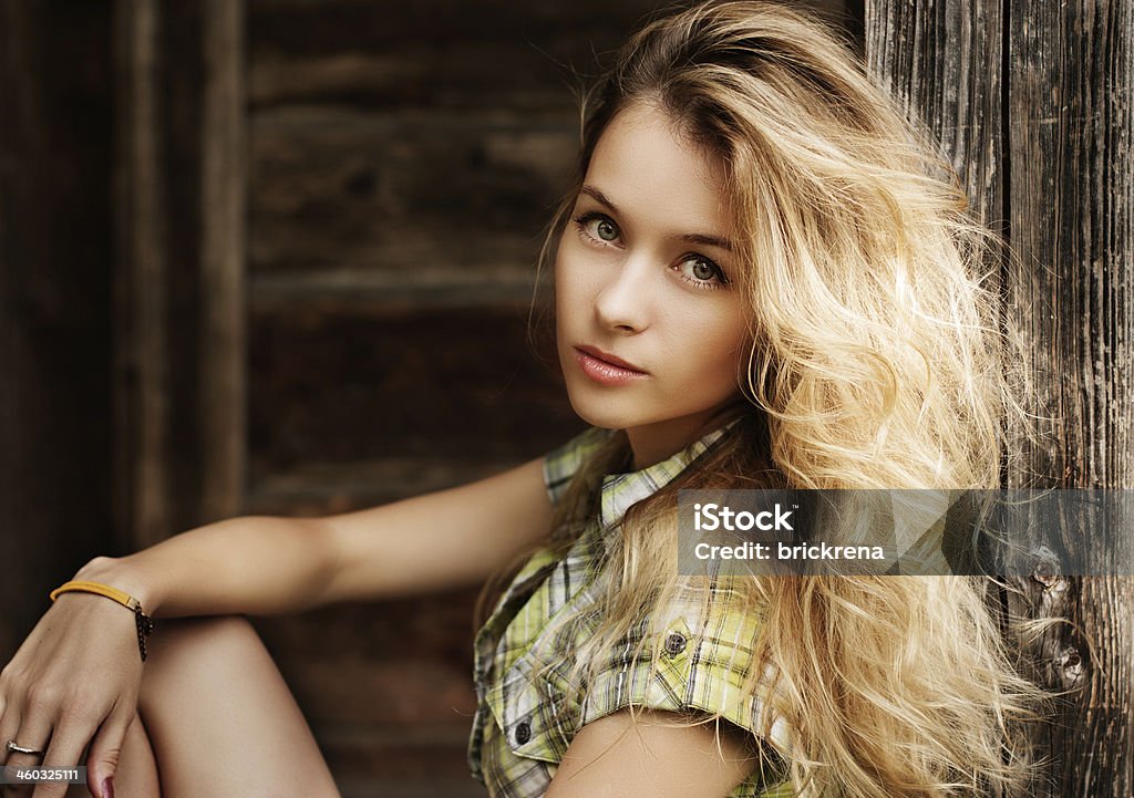 Portrait of Blonde Woman at the Wooden Background Portrait of Beautiful Blonde Woman on Wooden Background Adult Stock Photo