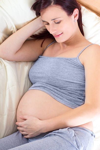 istock Pregnant woman lying in bed 460325237
