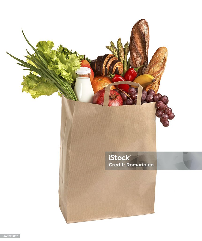 Shopping bag filled with groceries studio photography of assorted foods in brown grocery bag isolated over white background Paper Bag Stock Photo