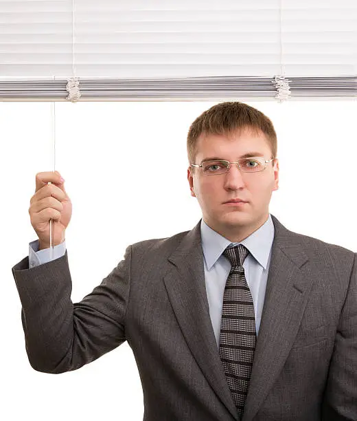 Office workers open white window blinds