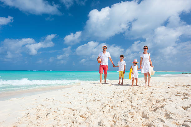 Family on a tropical beach vacation stock photo