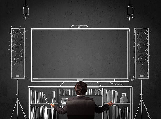 Businessman in front of a home cinema system Young businessman sitting and enjoying home cinema system sketched on a chalkboard home cinema system stock pictures, royalty-free photos & images
