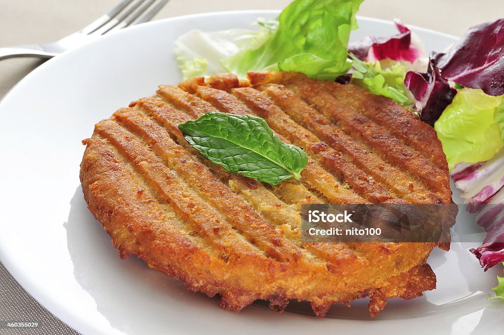 veggie burger a veggie burger in a plate on a set table Buffet Stock Photo