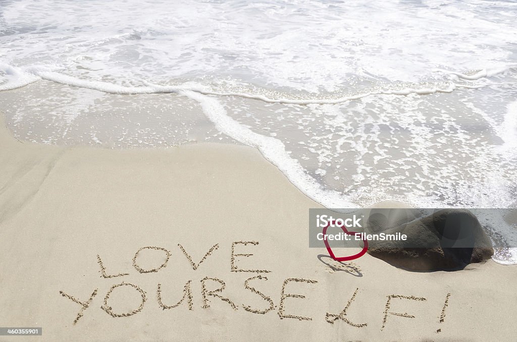 Sign "Love yourself" on the sandy beach Sign "Love yourself" with heart on the sandy beach by the ocean Alphabet Stock Photo