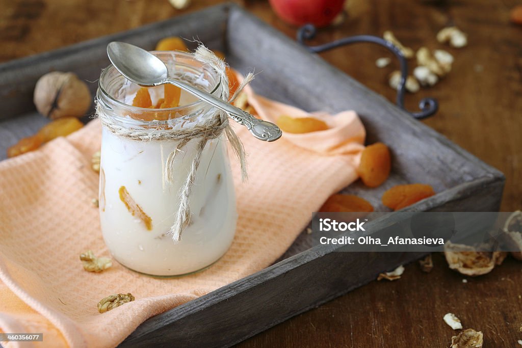 jar fresh yogurt with nuts and apricots on  old tray jar of fresh yogurt with nuts and apricots on an old tray, food Apricot Stock Photo