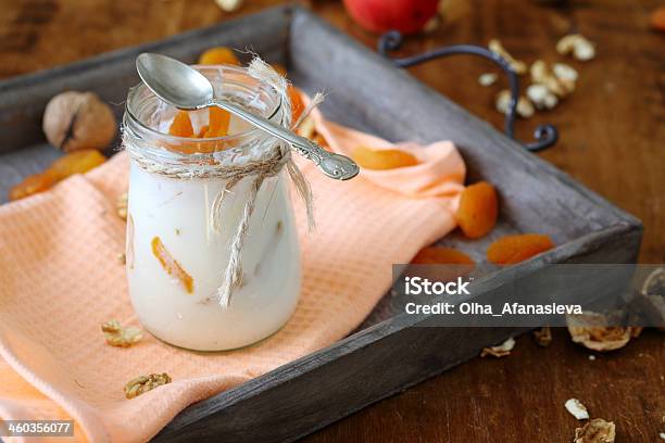 Jar Fresh Yogurt With Nuts And Apricots On Old Tray Stock Photo - Download Image Now