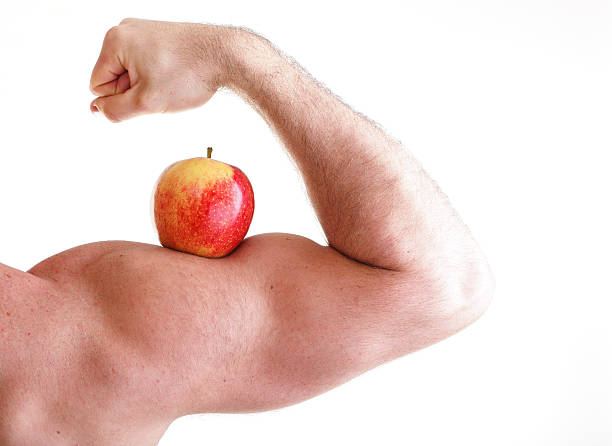 istock Red Apple on male Bicep Muscle 460357675